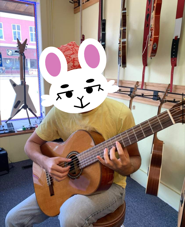 Me playing guitar at a guitar store